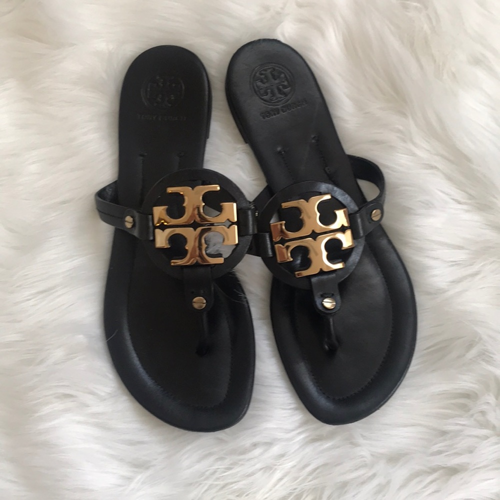 Tory Burch Miller flip flops with gold metal sign